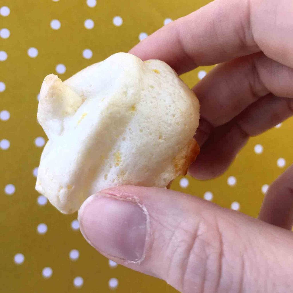 a hand holds a Keto almond meringue cookie