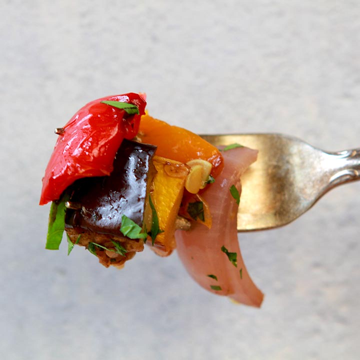 A fork holding a bite of low carb ratatouille