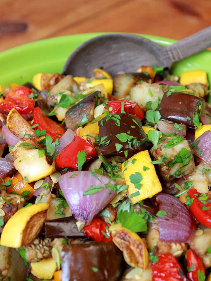 a spoon in a green bowl filled with Whole30 ratatouille