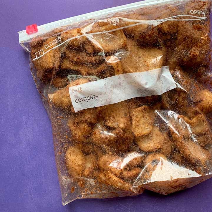 a plastic bag of sugar-free sweet pork rinds against a purple background