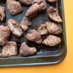 a gray cookie sheet covered with sweet keto cinnamon pork rinds