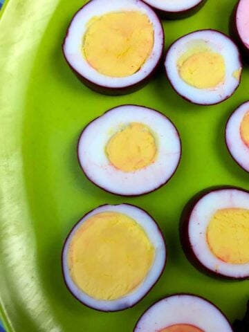 a green plate of Keto Pickled Eggs