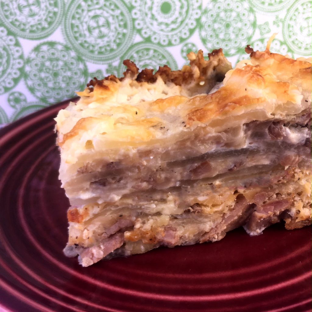 a red plate with Keto Scalloped Potatoes