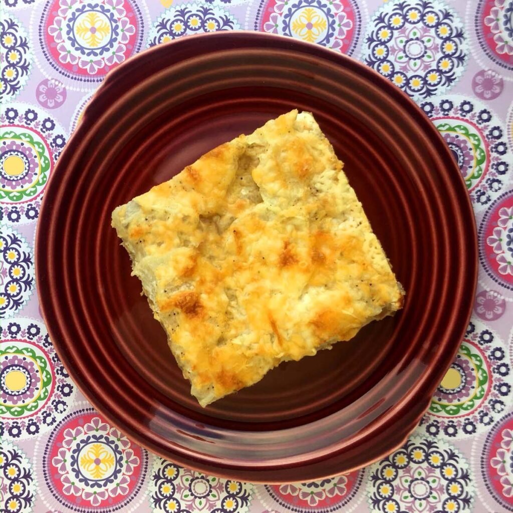 Keto Scalloped Potatoes with Beef on a red plate