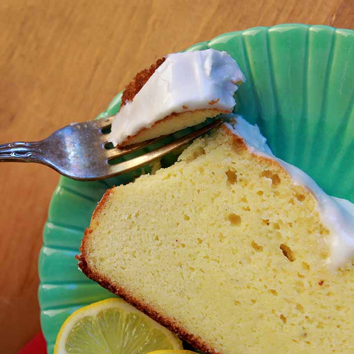 a fork cutting into a piece of sugar free lemon pound cake
