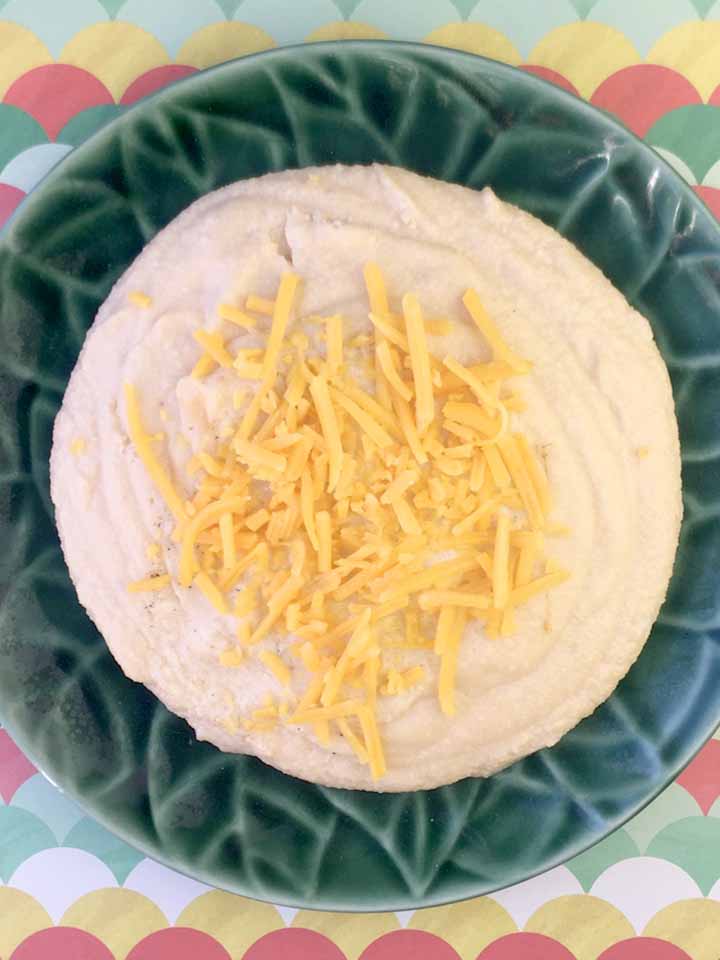 a top down view of a plate of low carb cheese grits