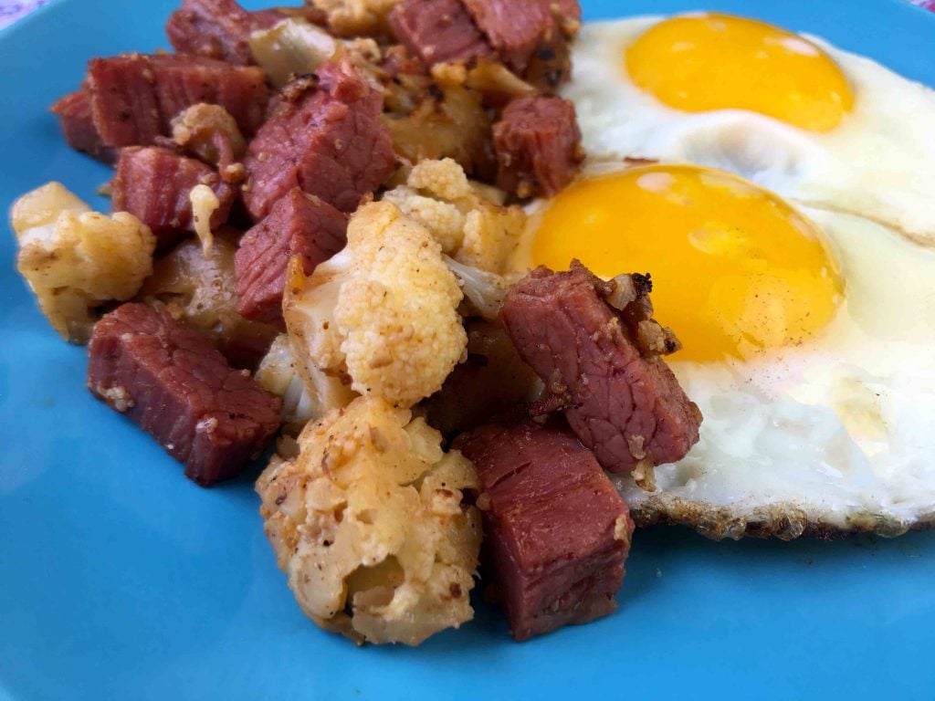 a plate of corned beef hash and eggs