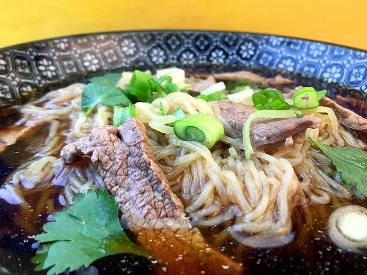 a close up image of a bowl of keto noodle soup