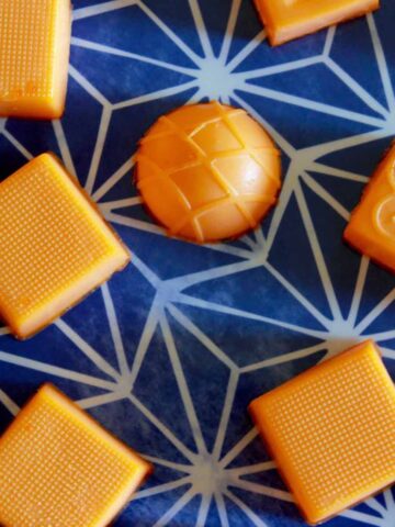 orange creamsicle gummies against a blue background