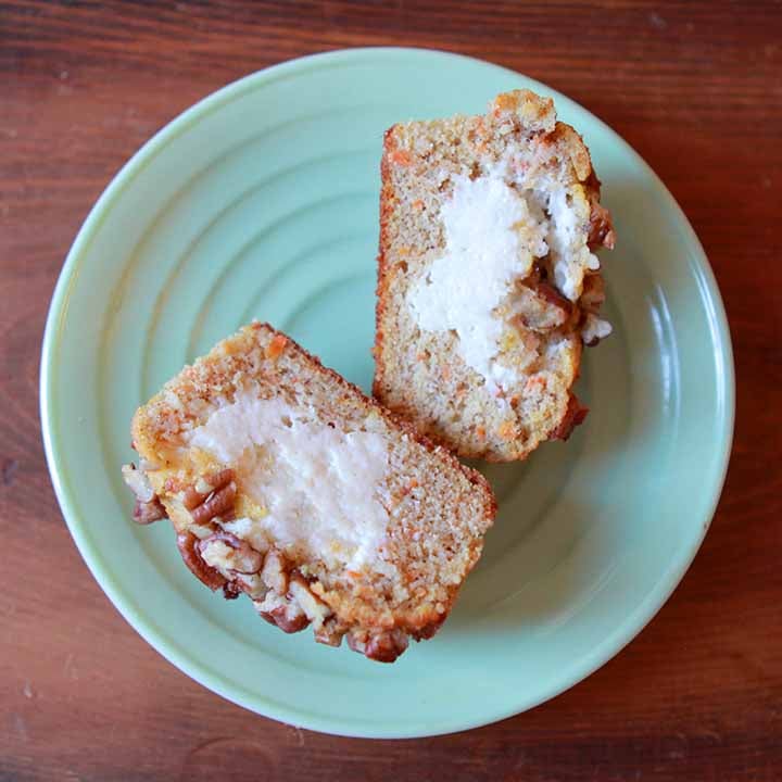 a top down view of a Keto cream cheese filled carrot muffin on a green plate