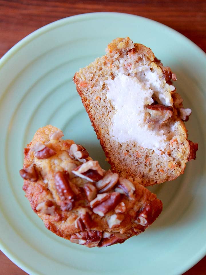 a top down view of a Keto cream cheese filled carrot muffin on a green plate