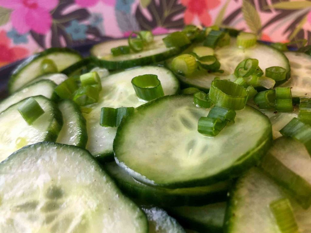 a close-up picture of a tangy keto cucumber salad