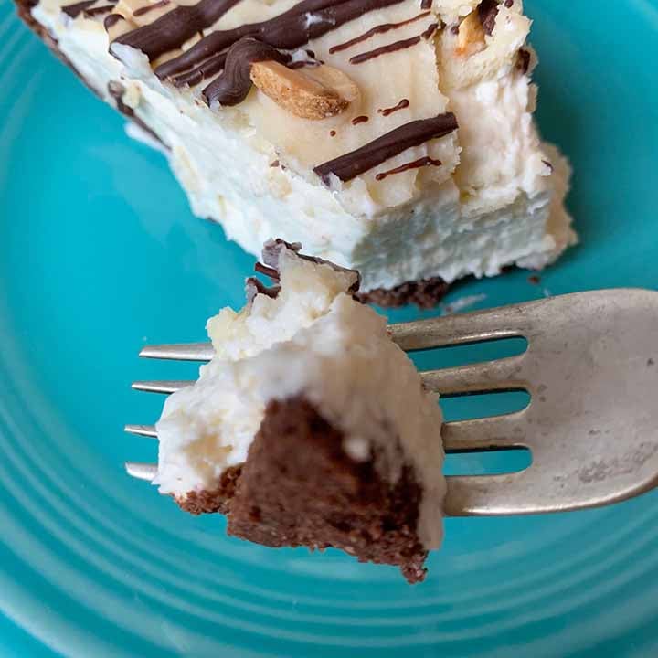a fork holds a bite of low carb Snickers Pie