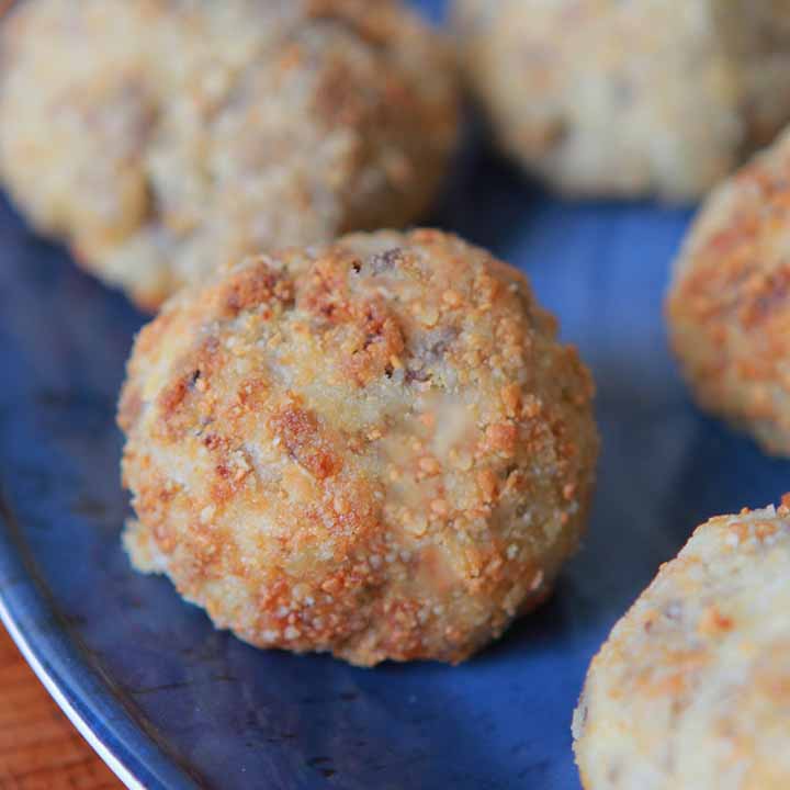 close up view of Keto sauerkraut sausage balls on a blue plate