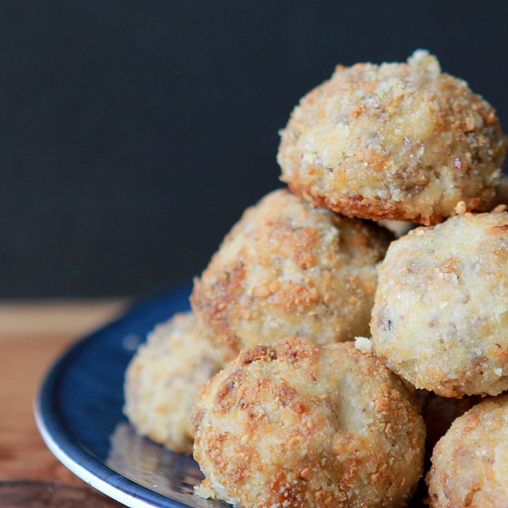 a pyramid made from Paleo sauerkraut balls against a black background