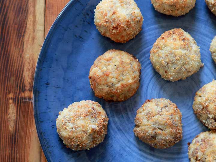 top down view of grain-free breaded sauerkraut balls on a blue plate