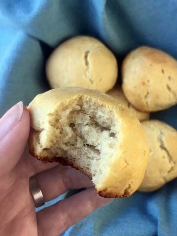 a hand holds a Keto Yeast Bread Dinner Roll