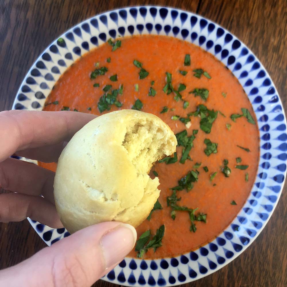 a hand holds a Keto Dinner Roll