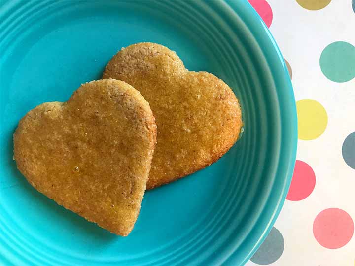 2 grain free gingerbread cookies on a blue plate against a spotted background