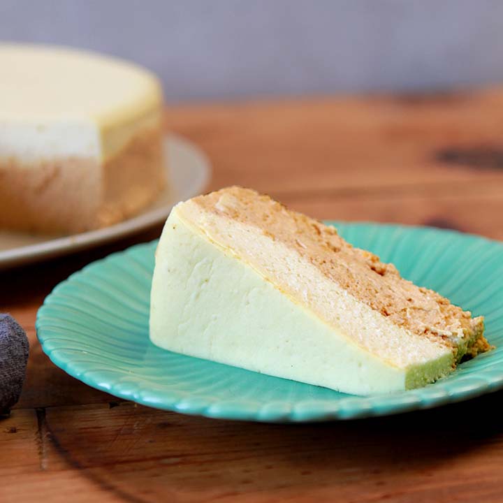 a slice of sugar-free pumpkin cheesecake on a green plate