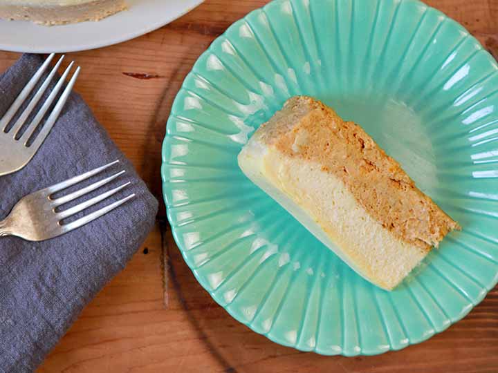 a top down view of a slice of easy pumpkin cheesecake on a green plate