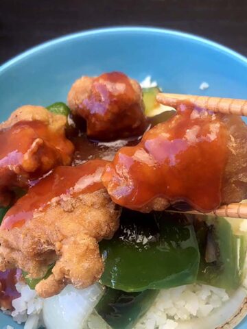 chopsticks hold Keto Sweet and Sour Chicken