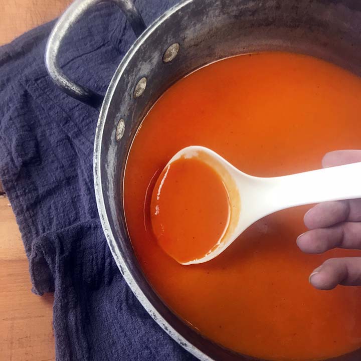a hand ladles out the soup