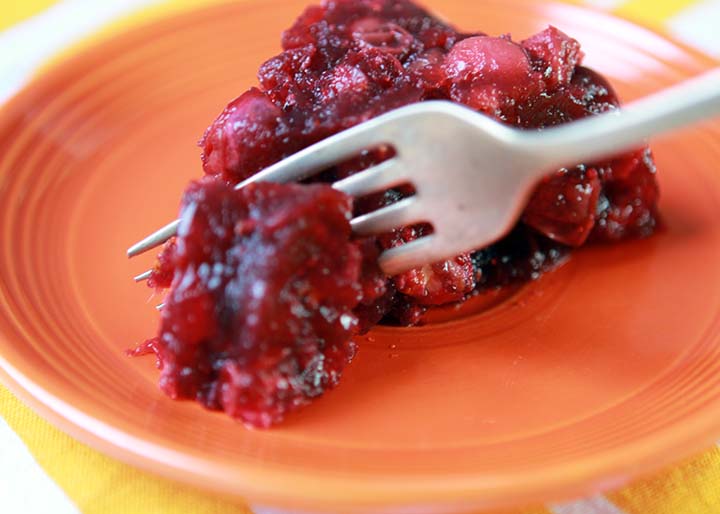 Low Carb Keto Cranberry Pecan Jello Salad on an orange plate with a fork