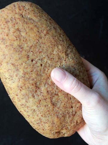 a hand holds a loaf of Keto Ciabatta