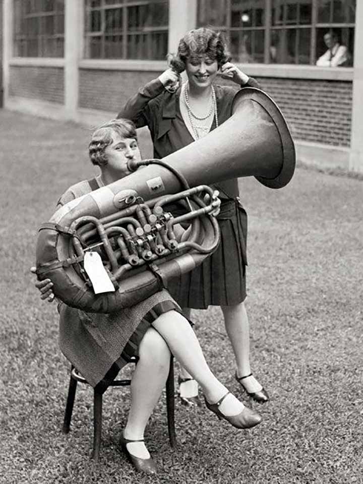 Old Timey Photograph of a woman playing a huge horn