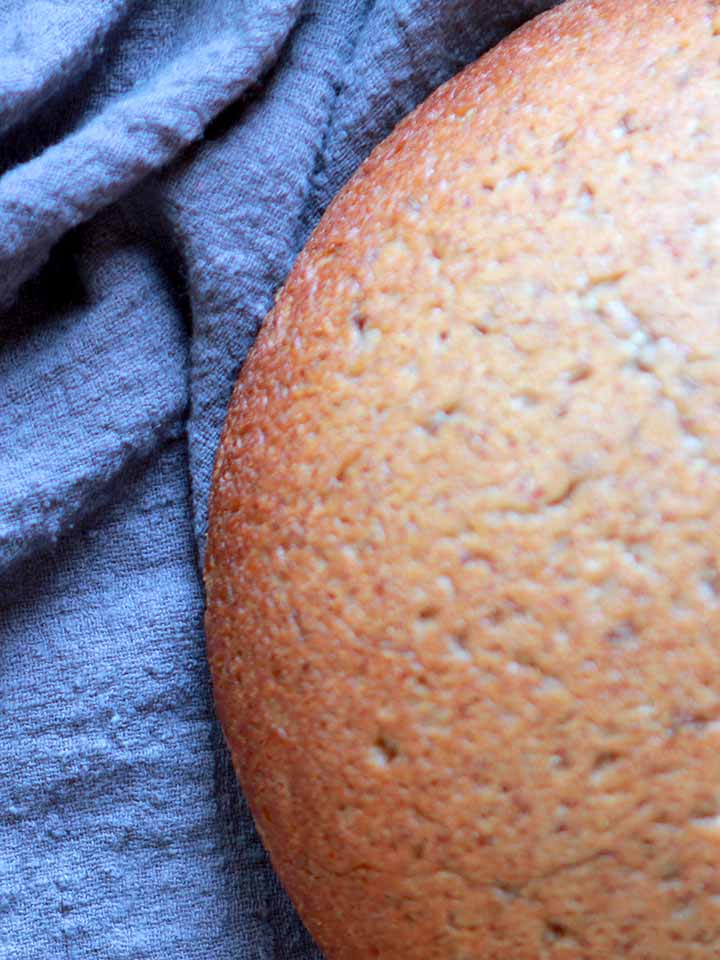 a close up of a loaf of low carb rye bread against a navy blue napkin