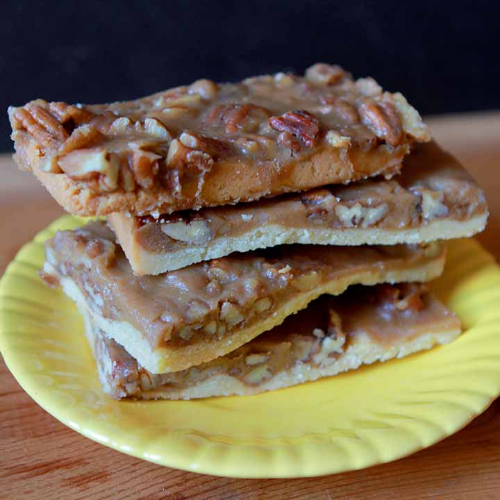A stack of Keto Pecan Pie Bars on a yellow plate