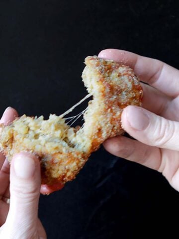 2 hands pull aport a Keto Arancini Rice Patty