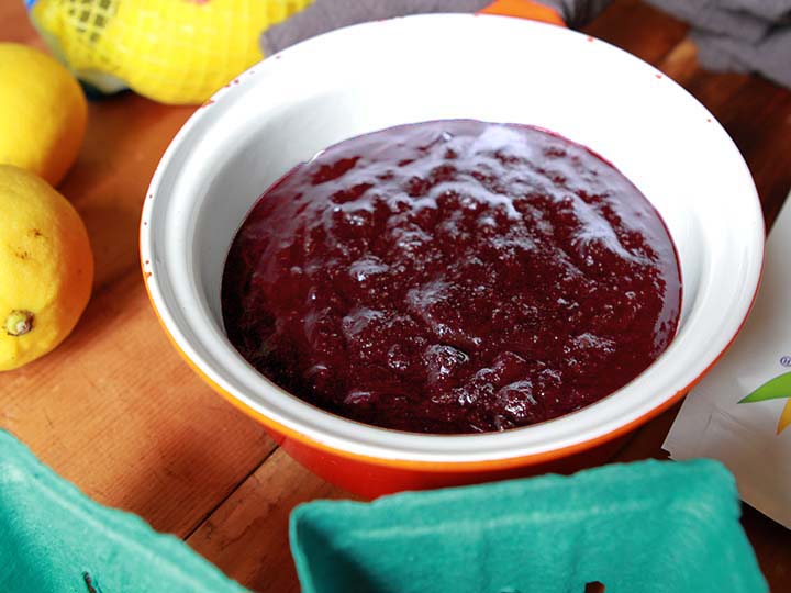 a sauce pan of Sugar Free Blueberry Jam surrounded by ingredients