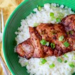 Close up photo of a healthy chili lime chicken thigh on a green plate