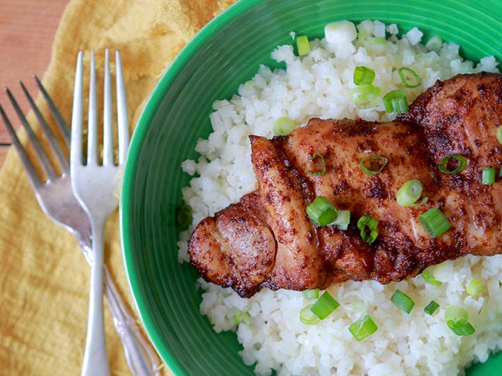 A Keto chili lime chicken thigh on a green plate