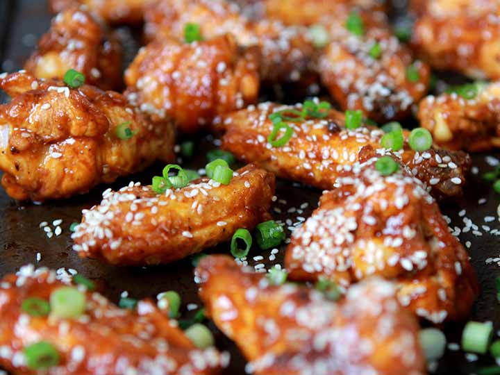 Close up picture of 8 Keto Korean Chicken Wings on a gray cookie sheet