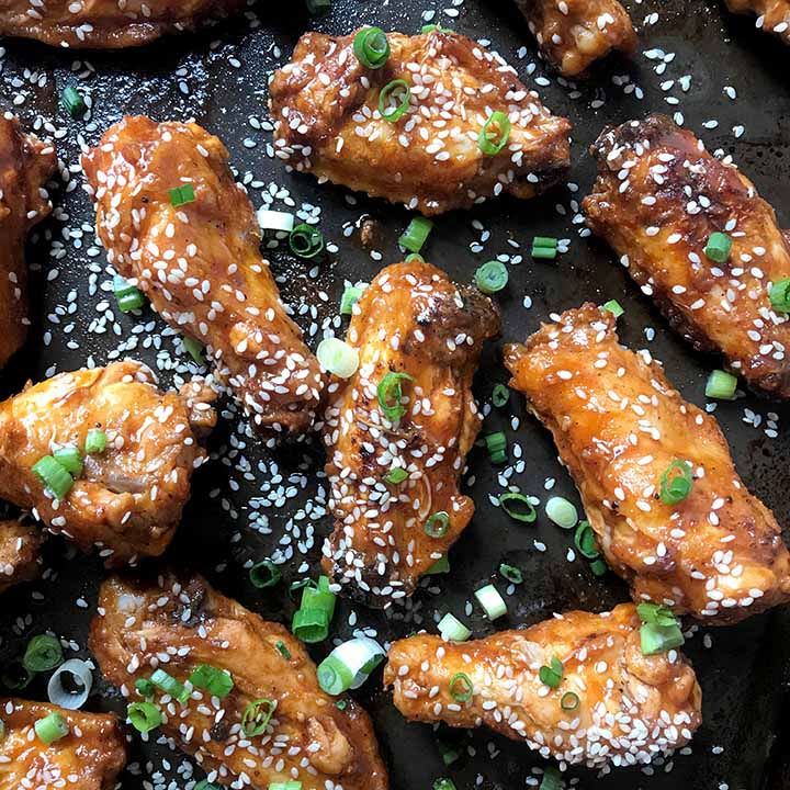 A top down view of 8 Low Carb Korean Chicken Wings on a gray baking sheet