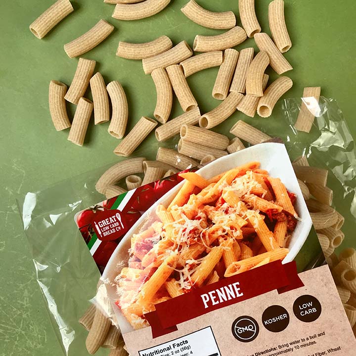A bag of Great Low Carb Bread Co Penne noodles with noodles spilling out