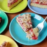 A forkful of low carb keto strawberry crumb cake against a blue plate