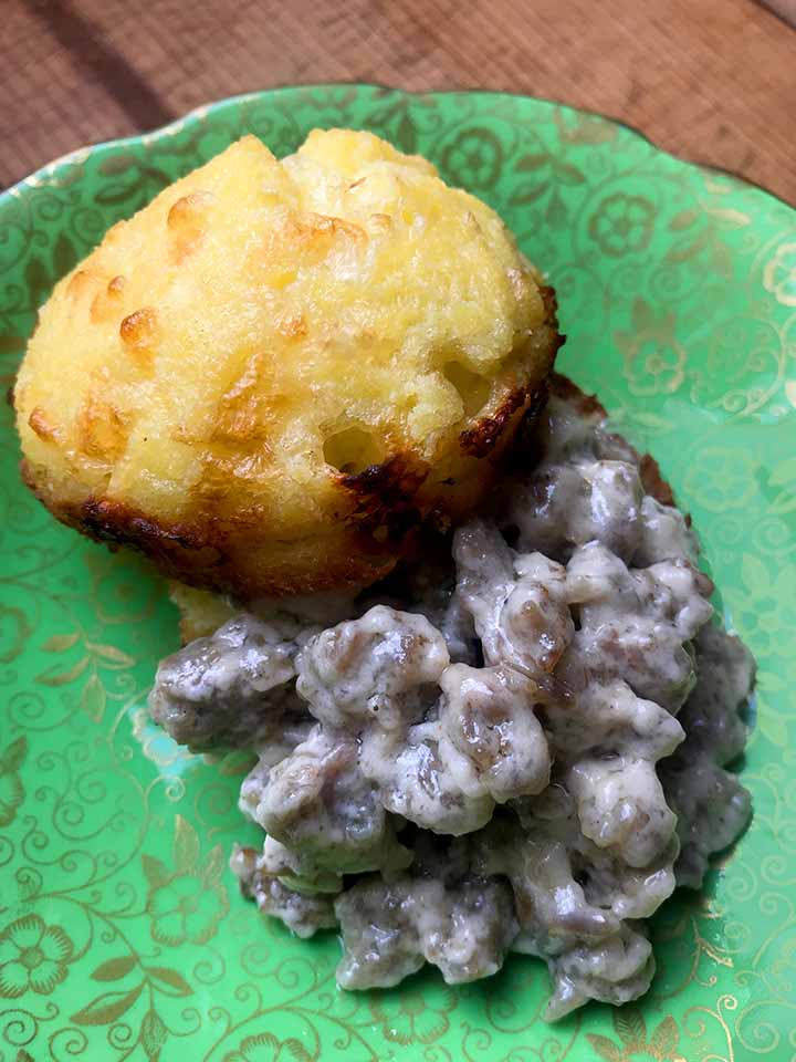 a close up of Keto Biscuits and Gravy on a green plate