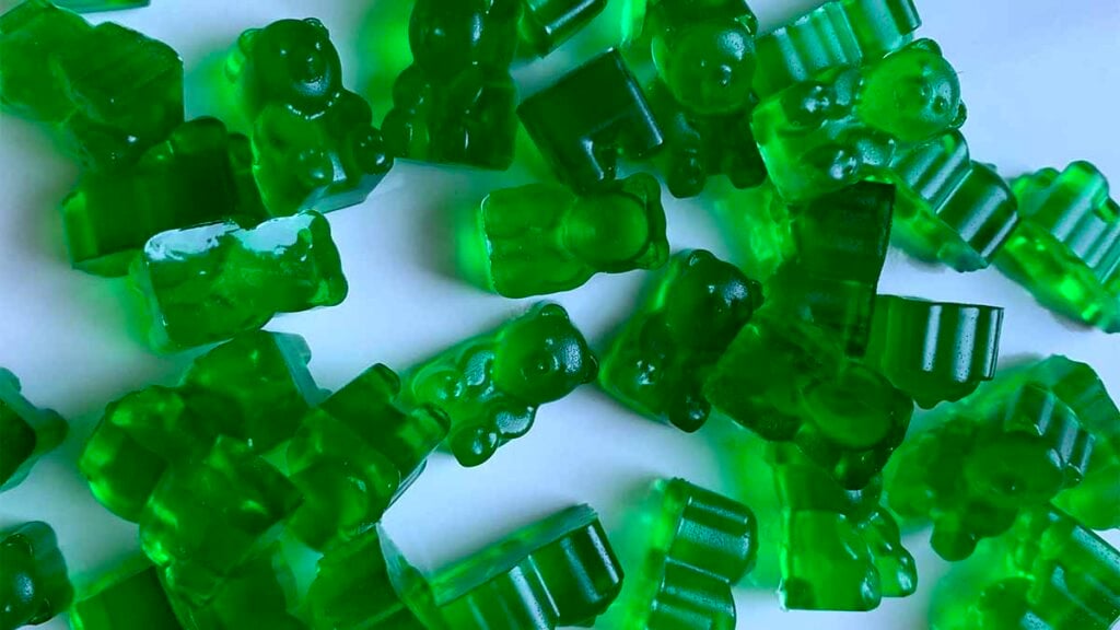 a pile of green sugar-free gummy bears