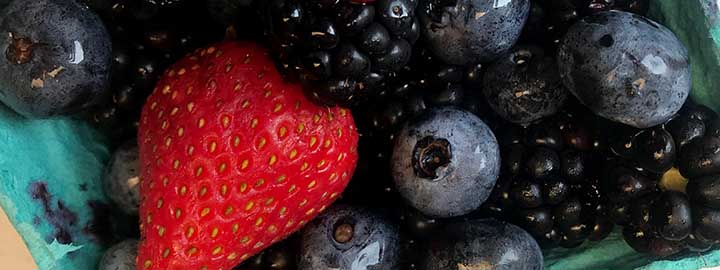 close up image of strawberries, blueberries and blackberries