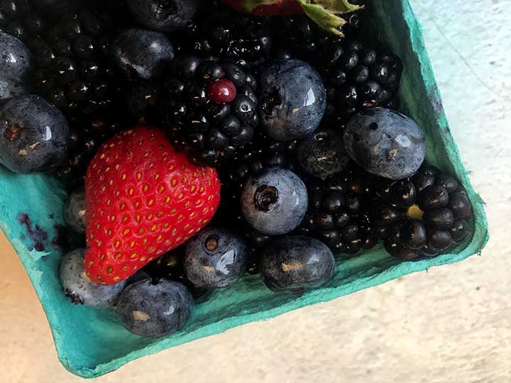 close up image of strawberries, blueberries and blackberries