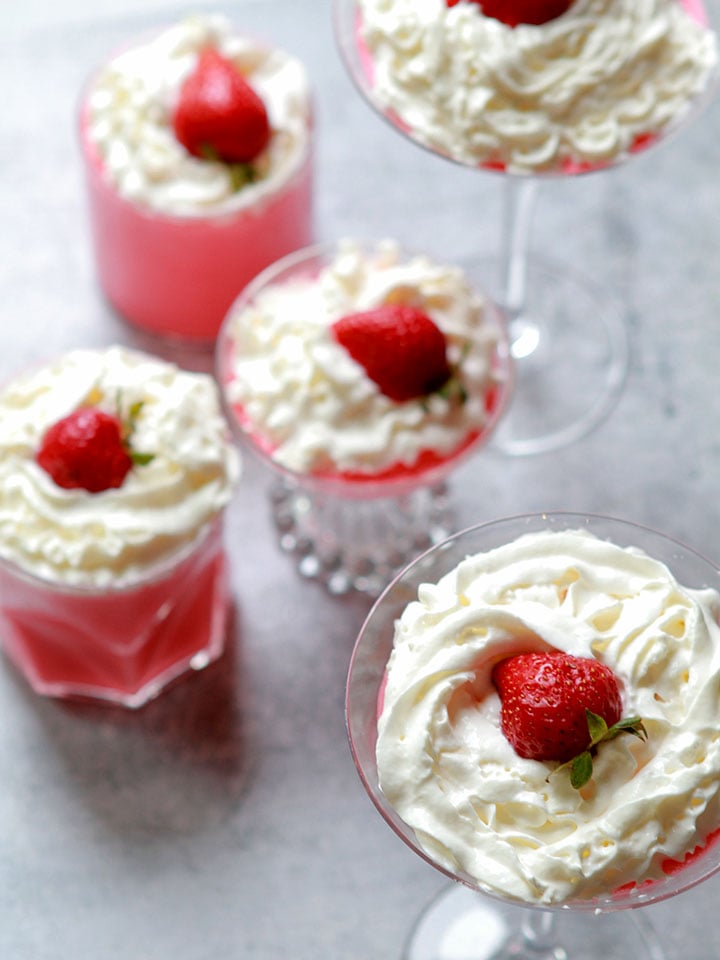 a group of glass containers holding Strawberry Fluff Salad