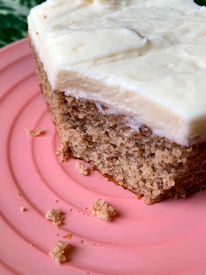 a pink plate holds a slice of low carb spice cake