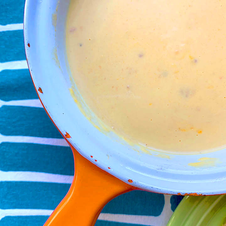 A close up view of a sauce pan filled with Paleo queso