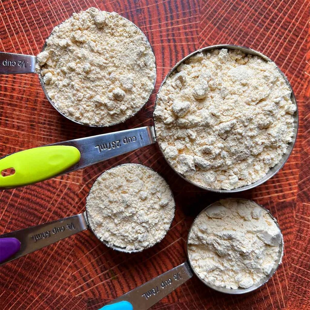 4 measuring cups filled with lupin flour