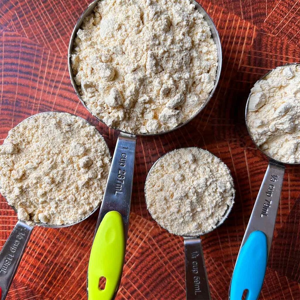 4 measuring cups filled with lupin flour