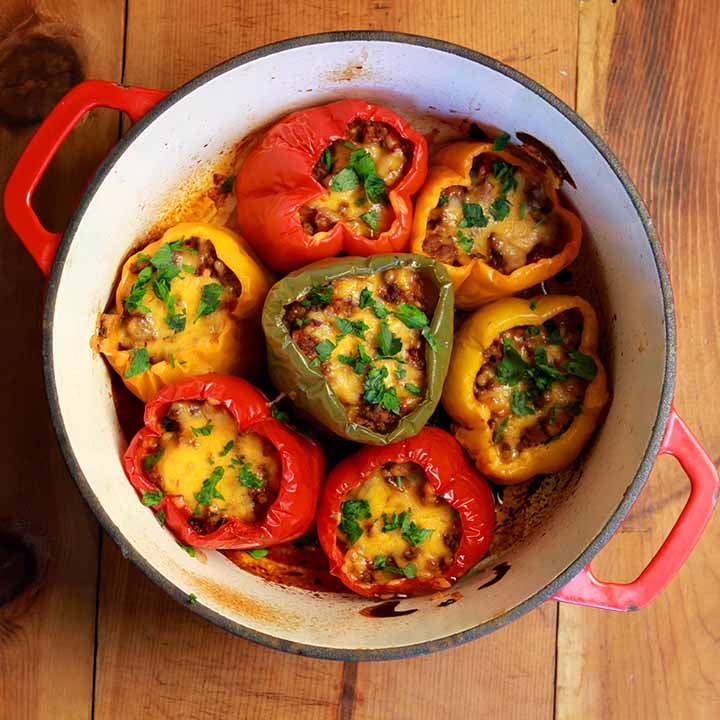 a top down view of a red and white baking dish filled with gluten free stuffed peppers